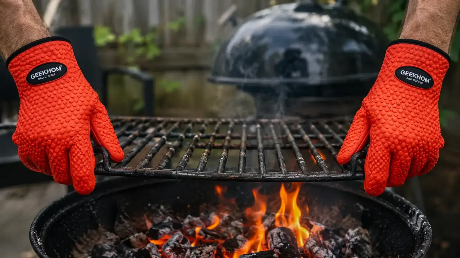 Close-up of GEEKHOM silicone BBQ gloves gripping a hot cast iron grate over live flames