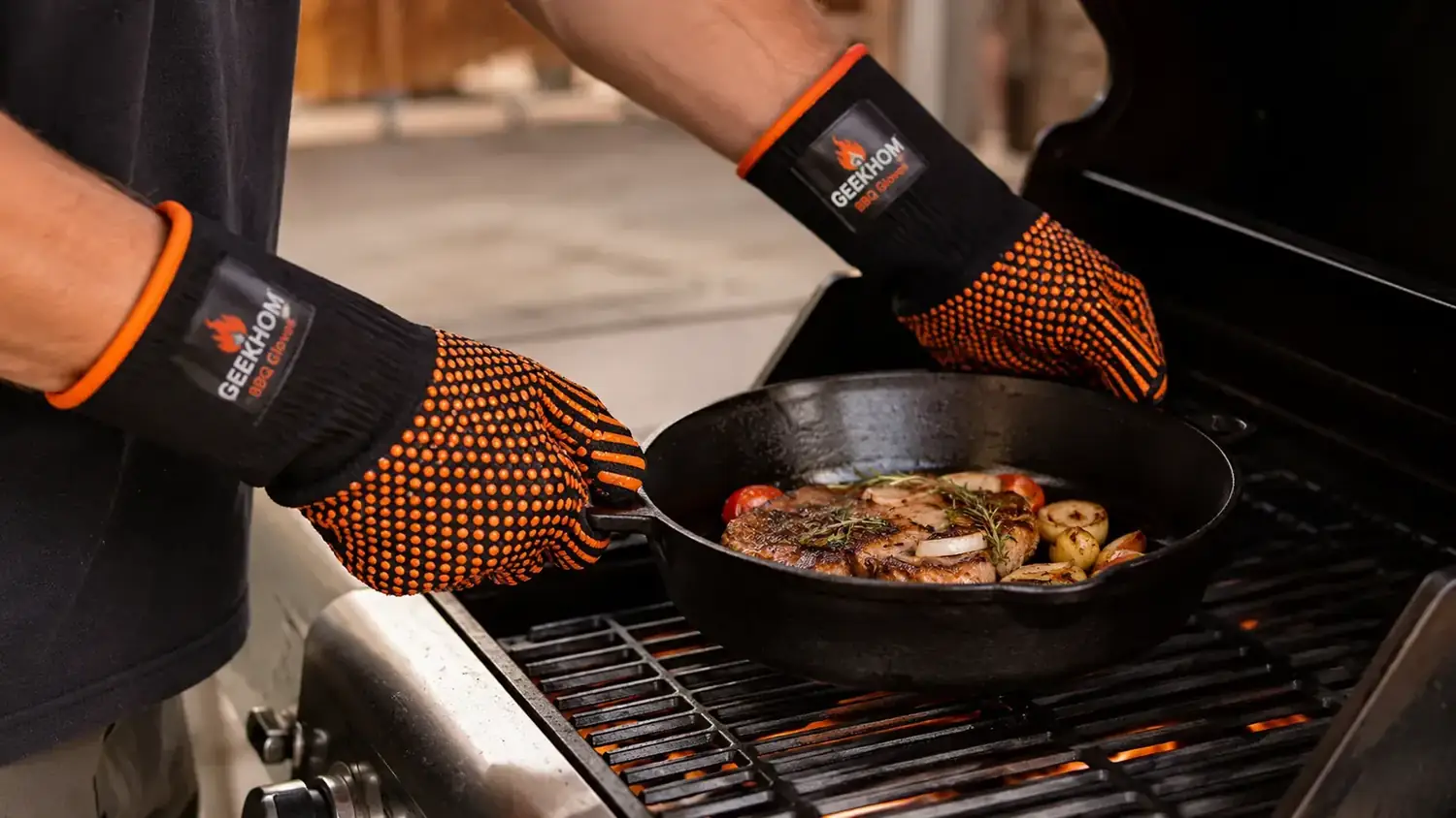 Person wearing long silicone BBQ gloves gripping a cast iron skillet handle on a hot gas grill